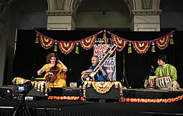 Calendar (Ragamala event pictured, three performers sitting on a stage performing)